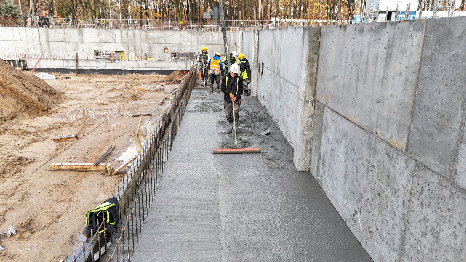 Zdjęcie pokazuje gładzenie betonu pod fundamenty nowej pływalni