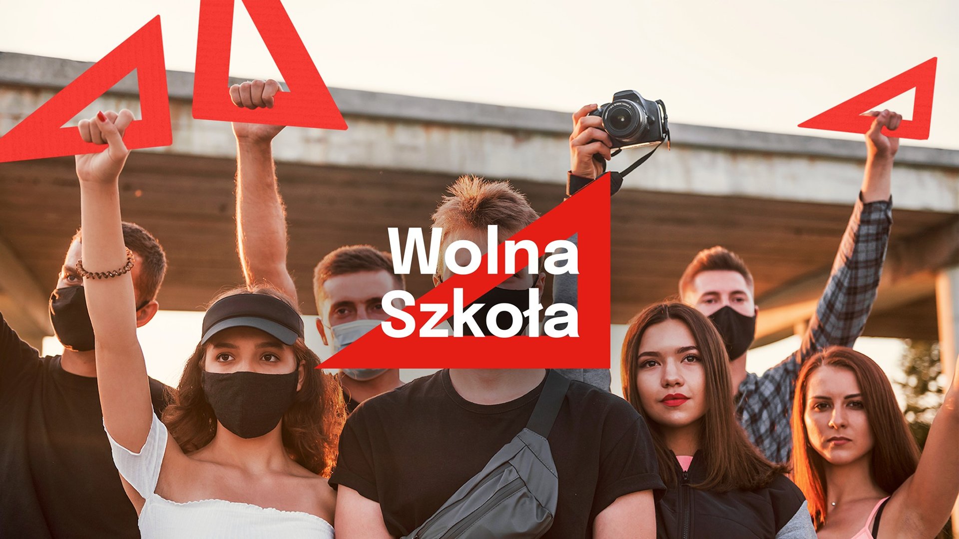 Zdjęcie przedstawia młodych ludzi, trzymających czerwone ekierki. - grafika artykułu