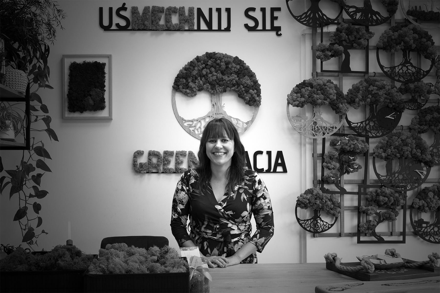 Ewa Włodarska w swojej pracowni Greenowacja. W tle na ścianie nazwa pracowni i prace z chrobotkiem reniferowym