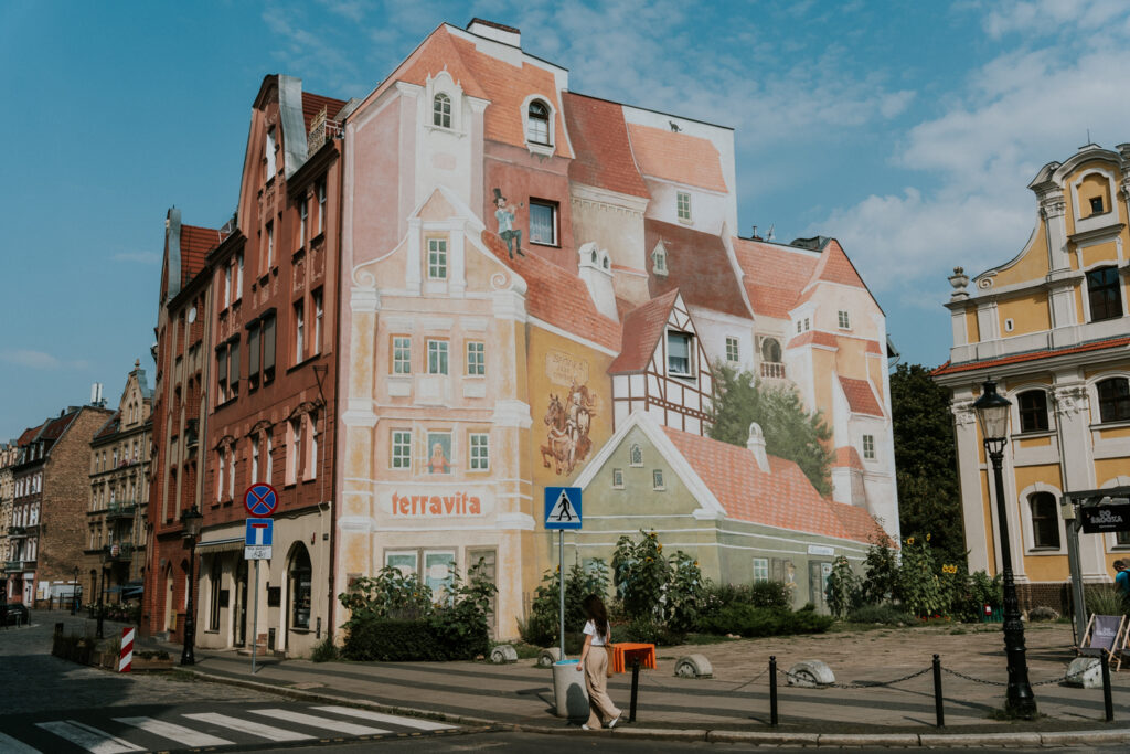 Na zdięciu jest mural na Śródce, które ukazuje postaci historyczne i kulturowe związane z Poznaniem, tworząc wyjątkową atmosferę w tej części miasta. - grafika artykułu