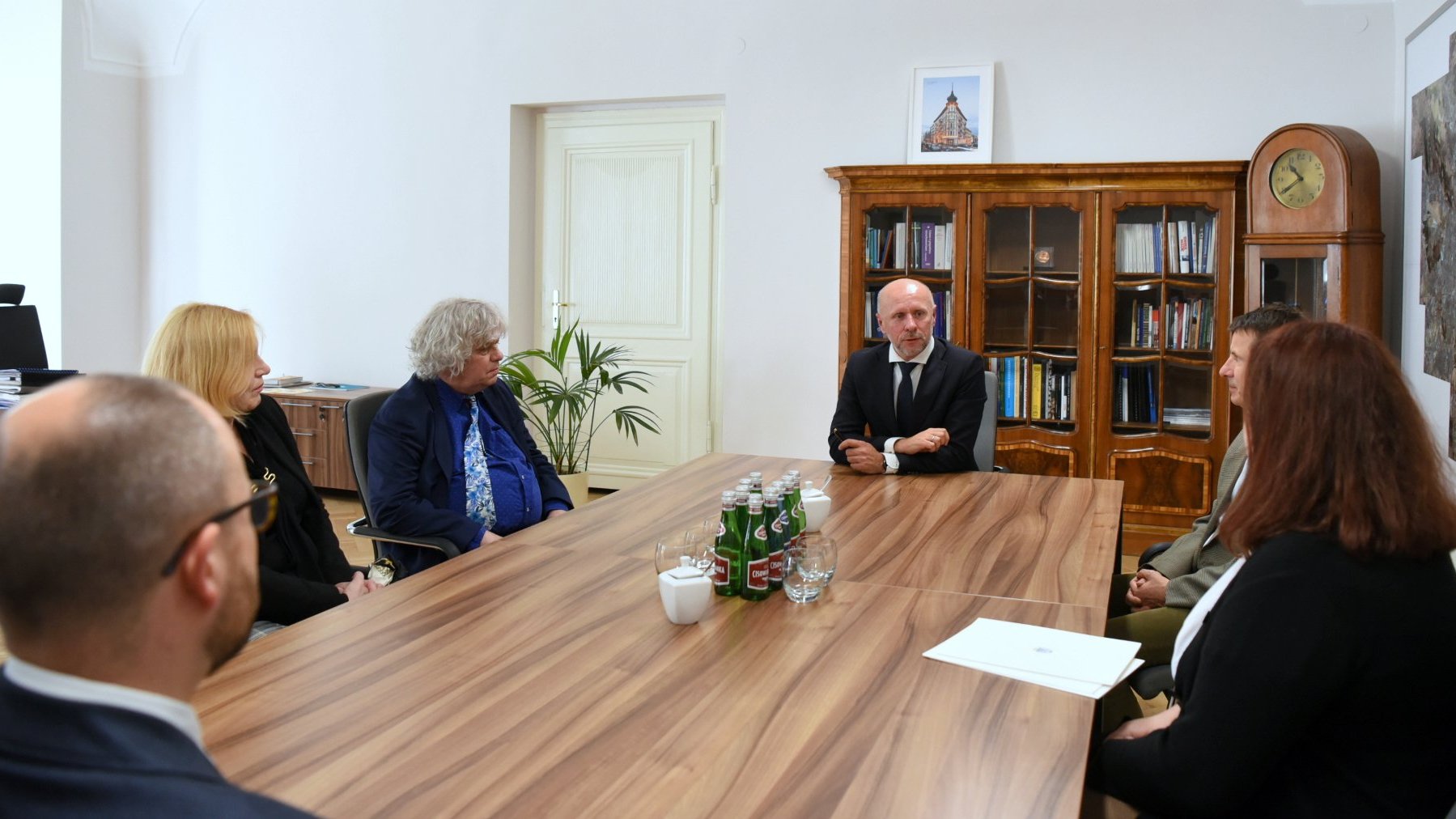 Zdjęcie przedstawia pracowników UAM oraz Miasta siedzących za stołem.