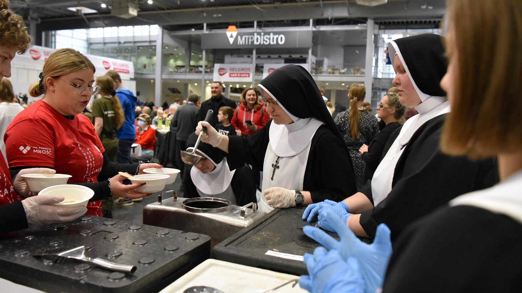 Na zdjęciu wolontariusze rozdający jedzenie