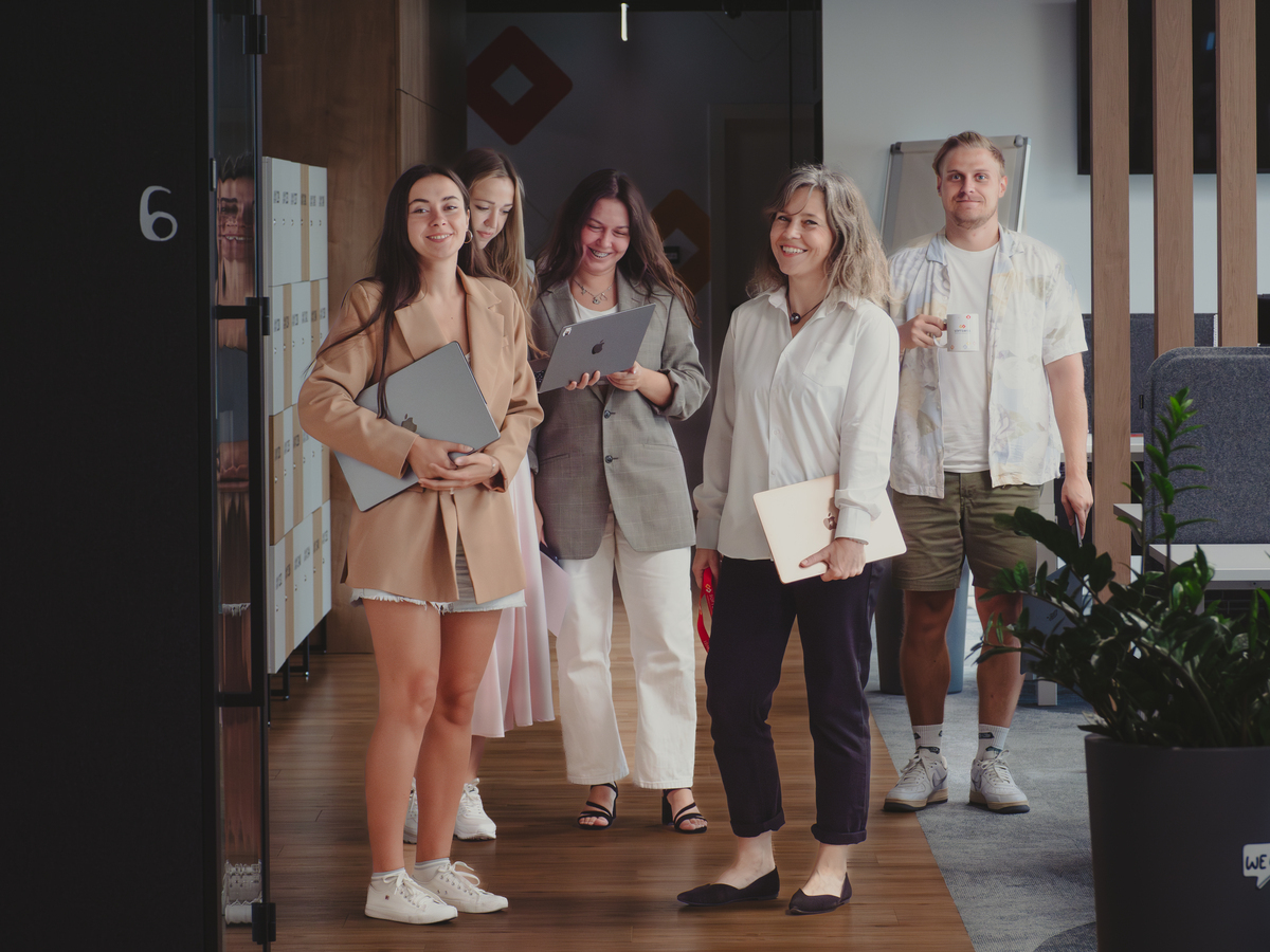 SOFTSWISS's Partner Development Centers in Poznań Support Green Initiatives Group of smiling women in office.