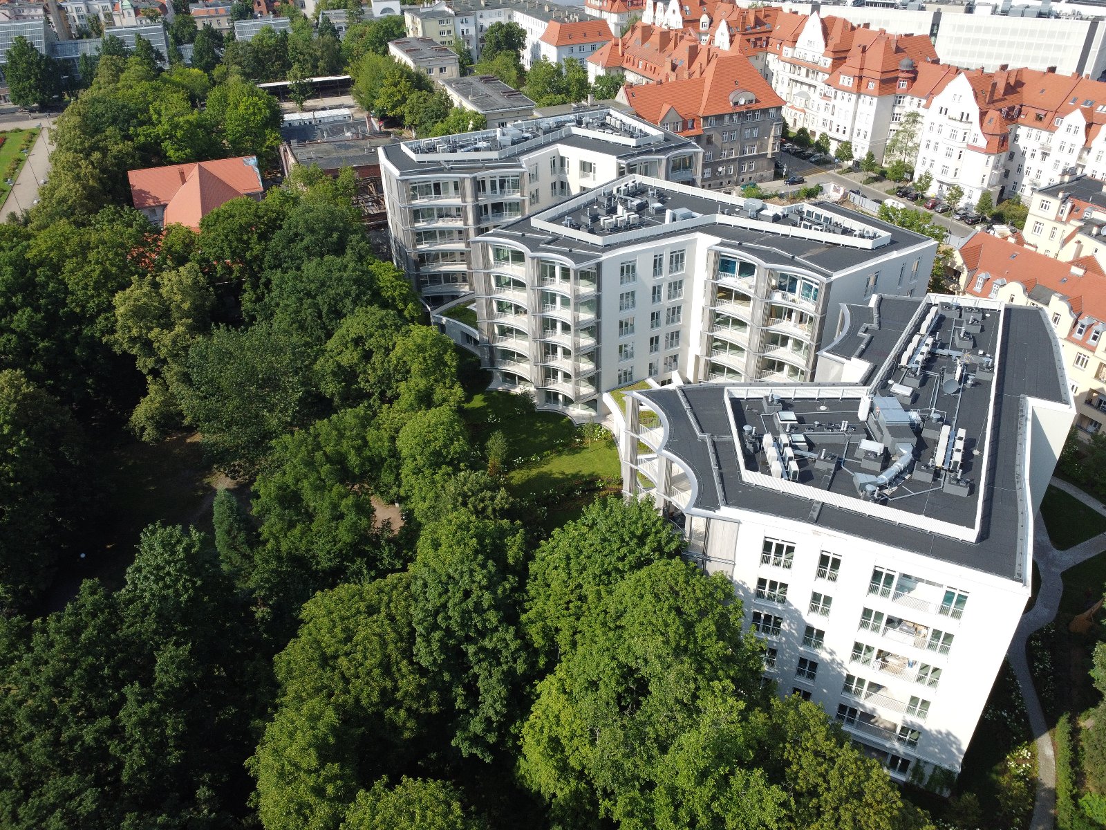 Bird's eye view photo of the Perfumiarnia development. In the distance, the urban development of Jeżyce, on the left, greenery can be seen. - grafika artykułu