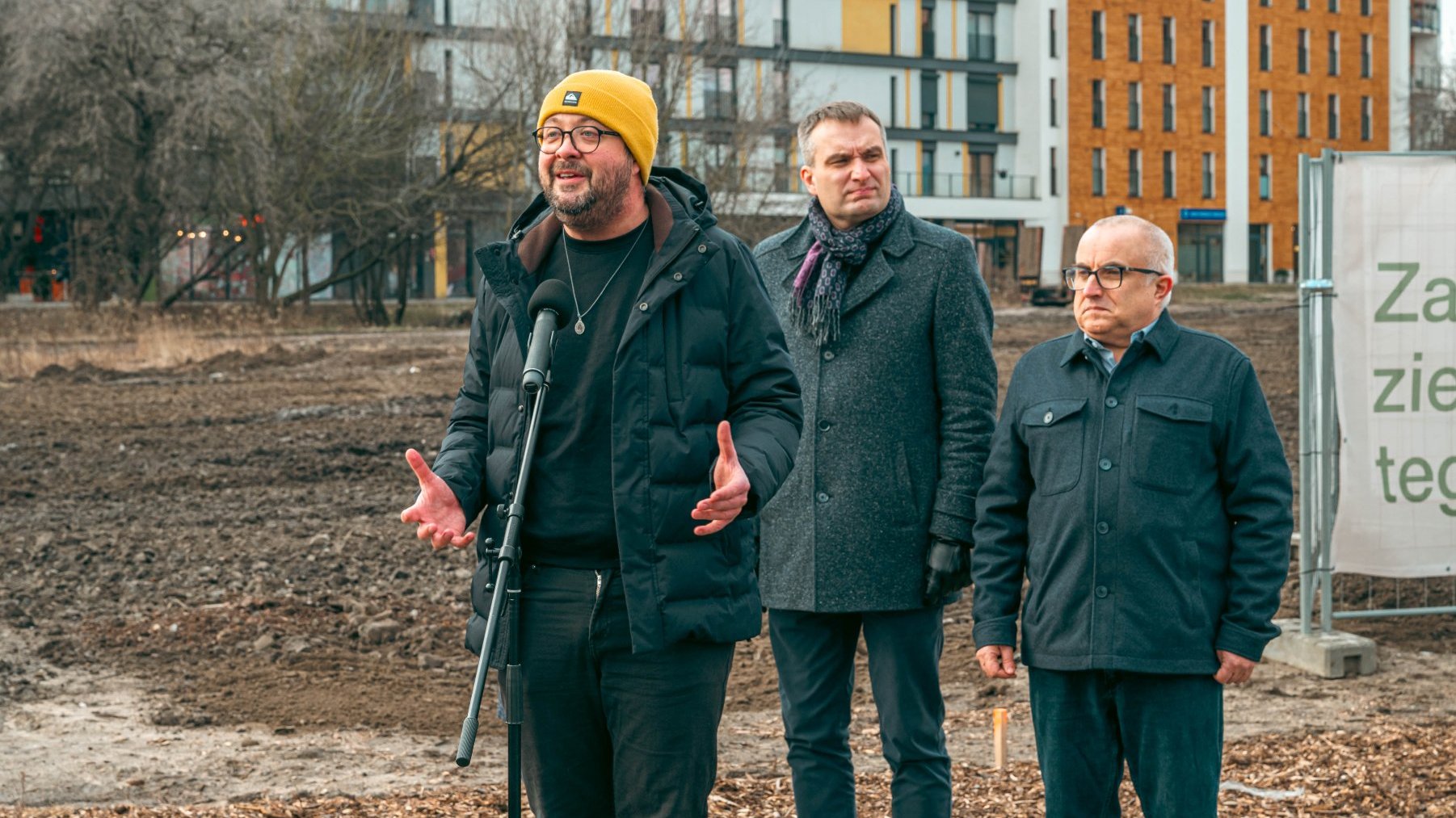 Galeria zdjęć przedstawia konferencję prasową poświęconą powstaniu parku na Łacinie. Na pierwszym planie widać grupę osób, w tle bloki i teren, na którym ma powstać park.