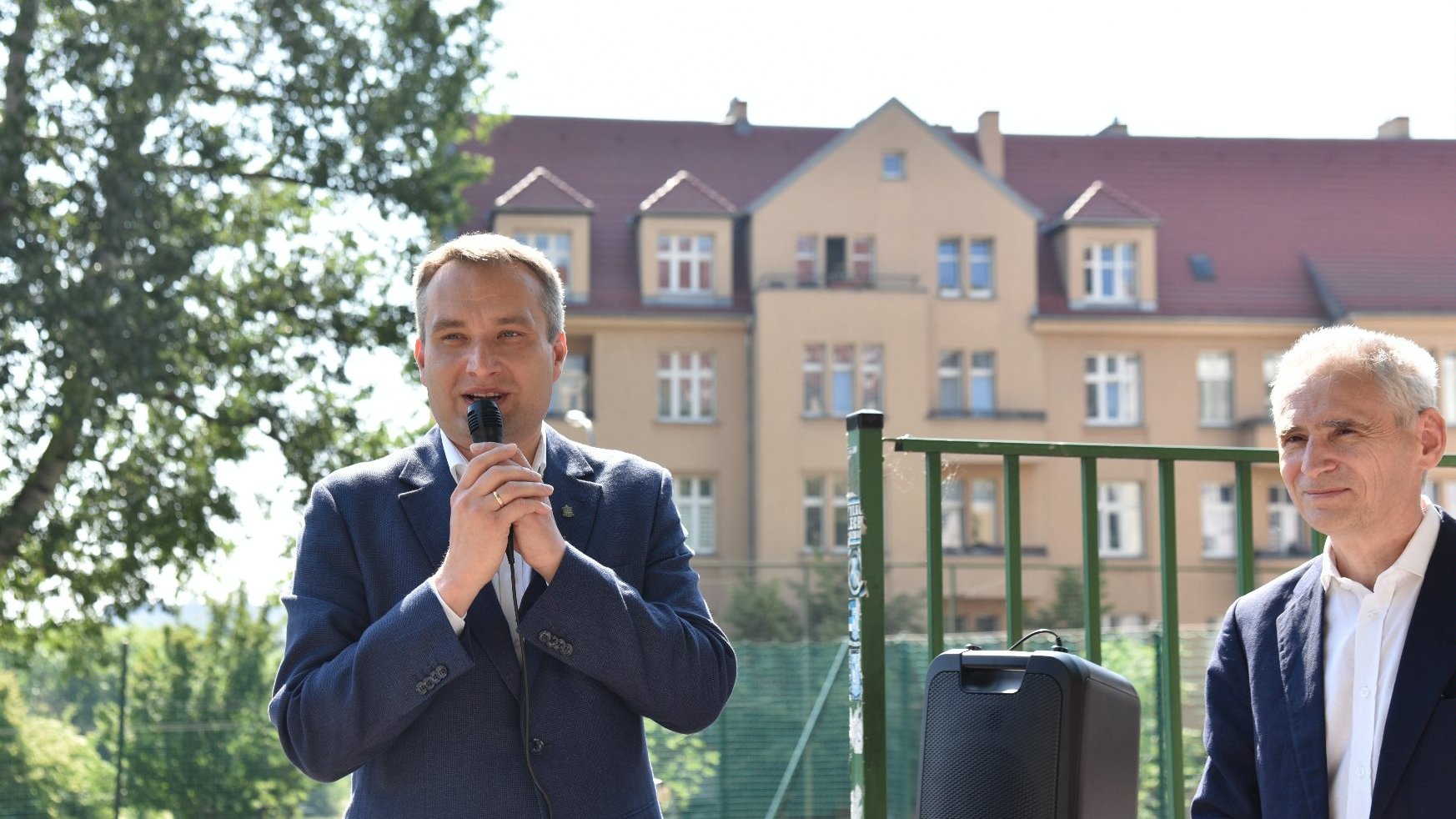 Zdjęcie przedstawia wiceprezydenta Wiśniewskiego przy mikrofonie. Obok stoi dyrektor szkoły.