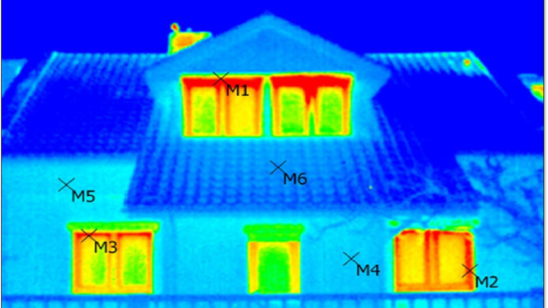 Zdjęcie przedstawia obraz z kamery termowizyjnej. Widać na nim obrys domu. Kolorami zaznaczono miejsca, w których ucieka ciepło.