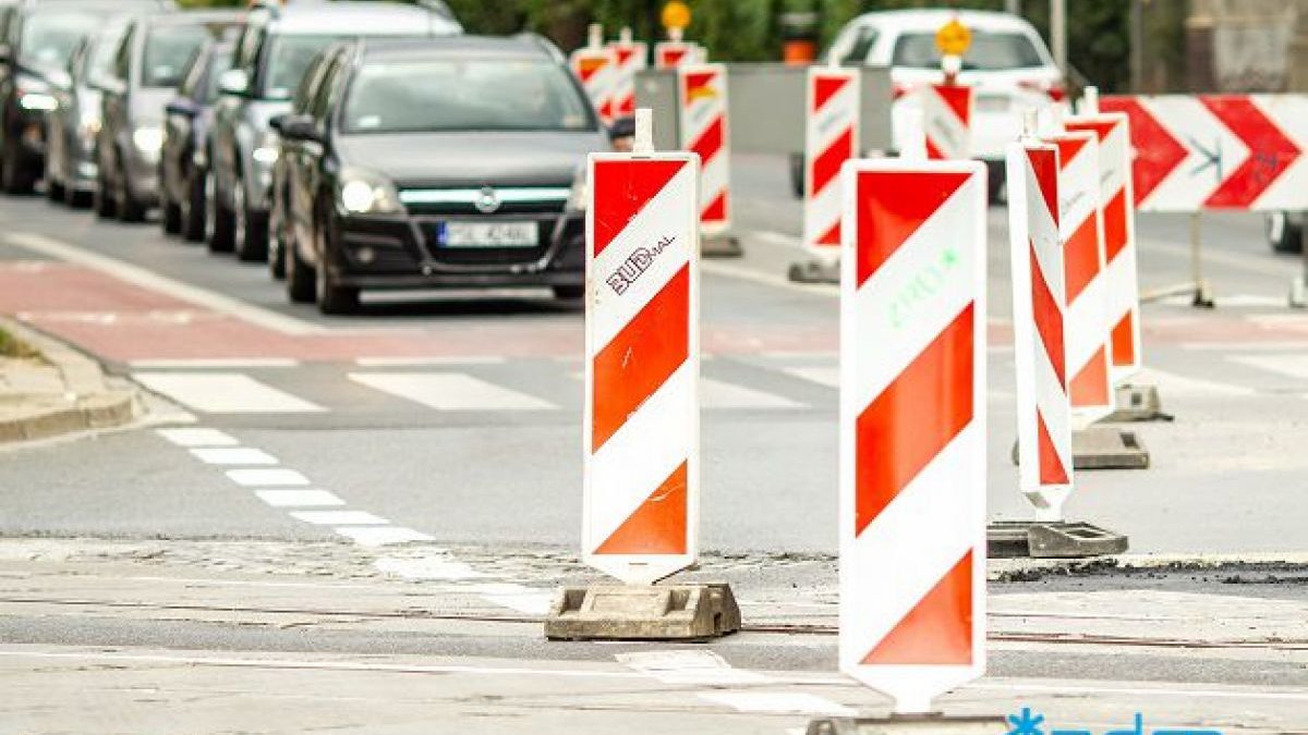 Na zdjęciu zwężenie jezdni, widać oznakowanie, w tle samochody