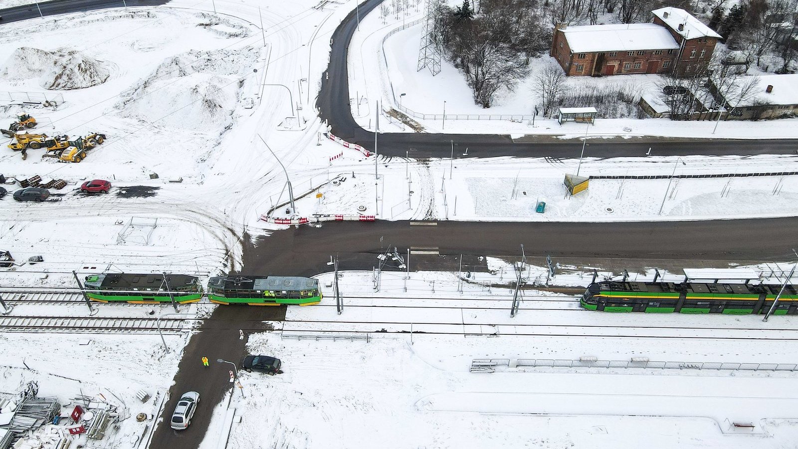 Widok z lotu ptaka, jeden tramwaj stoi na wiadaukcie, drugi z niego zjeżdża