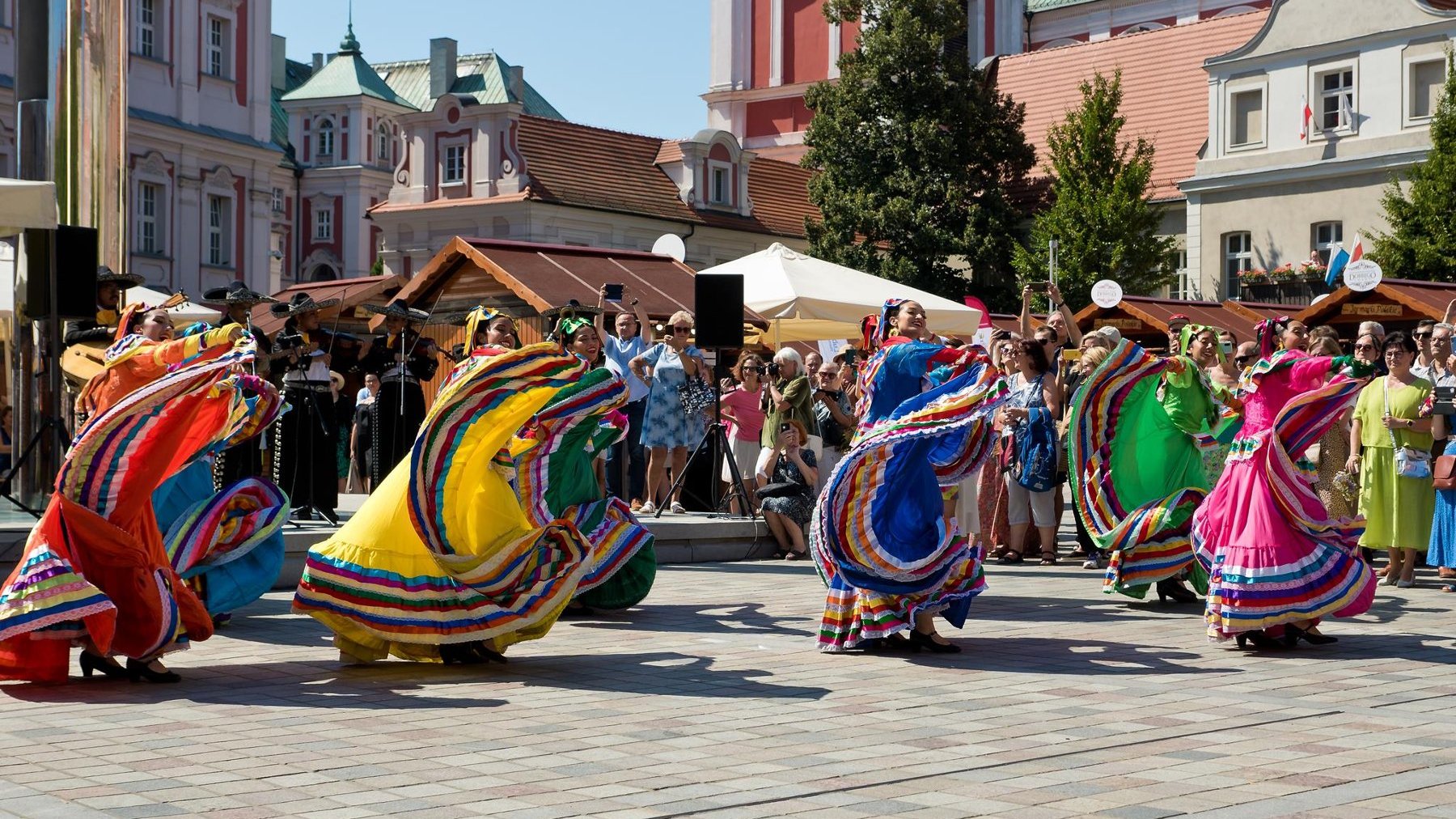 Zdjęcie z zeszłorocznej edycji Festiwalu dobrego Smaku. Na pierwszym planie tańczące kobiety w kolorowych strojach