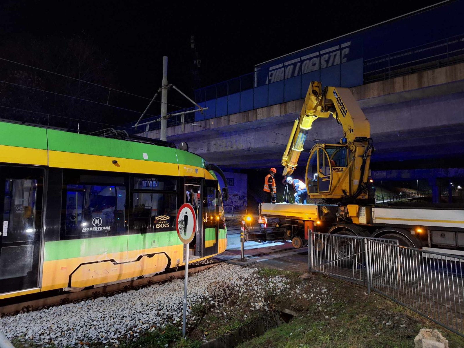 Zdjęcie przedstawia zepsuty tramwaj oraz maszynę i ludzi, którzy będą go holować lub naprawiać. - grafika artykułu