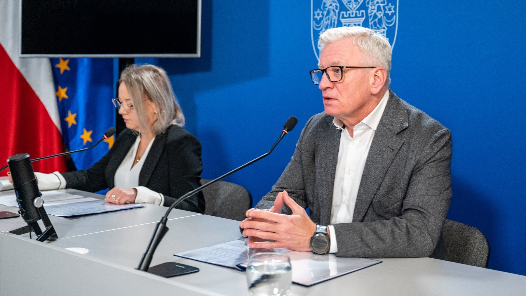 Na zdjęciu dwie osobyz a stołem konferencyjnym, w tym prezydent Poznania