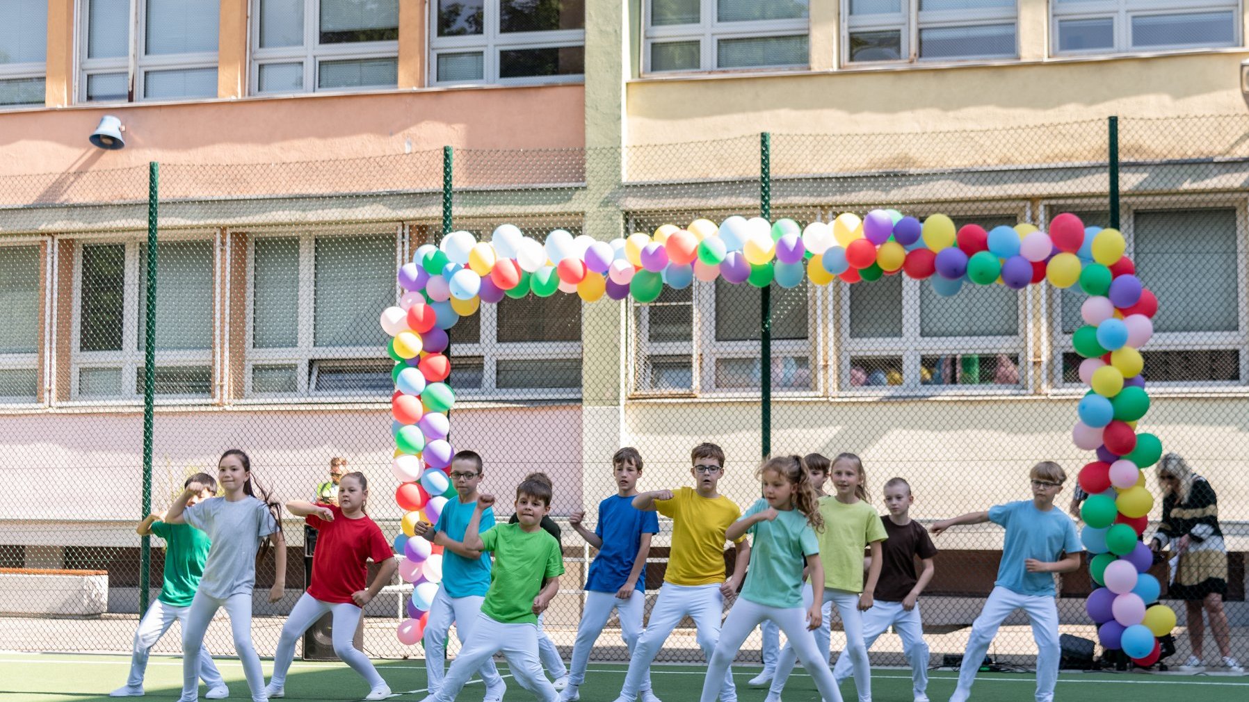 Zdjęcie przedstawia tańczących na boisku uczniów.