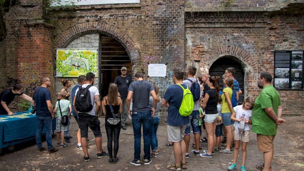 Photo of a group of people standing in front of a fort.