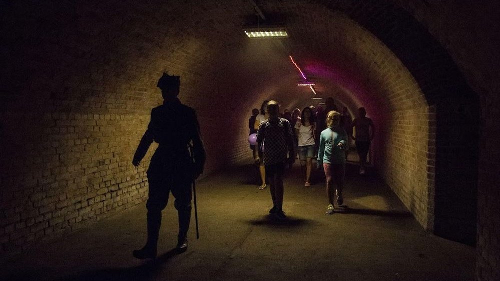 A photo of a group of people sightseeing interior of the fort.