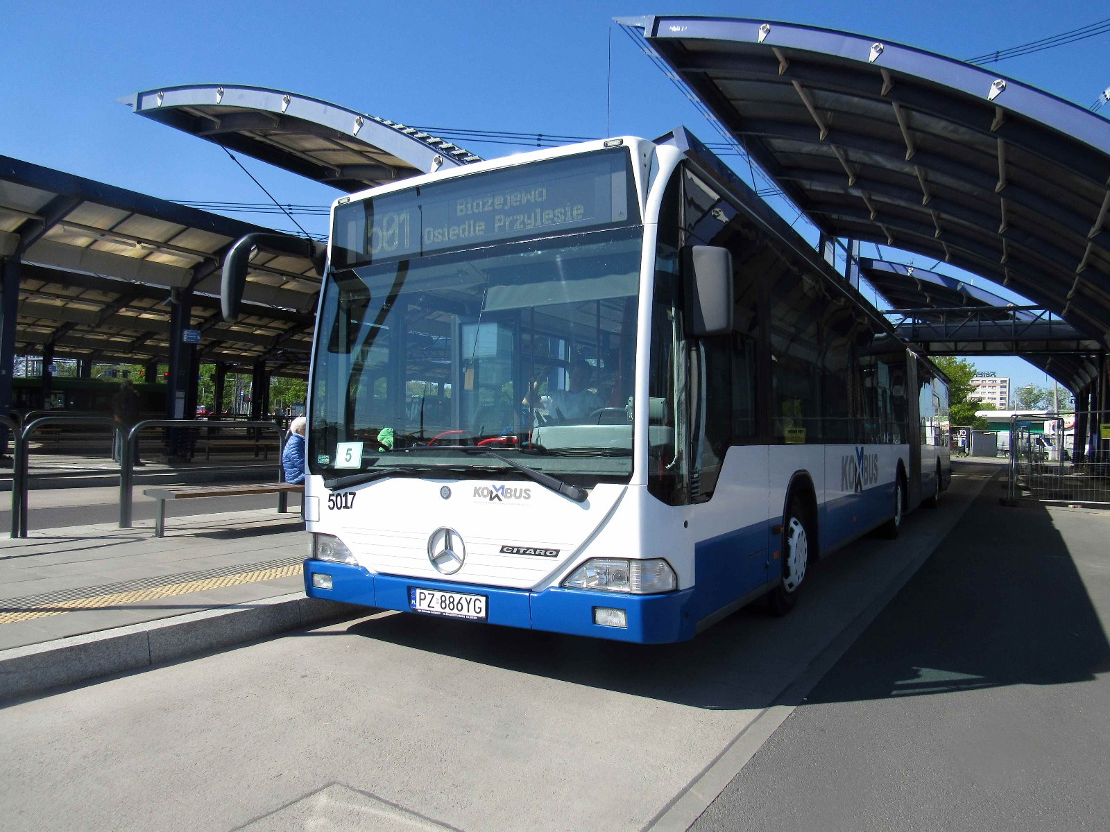 Zdjęcie przedstawia autobus podmiejski na przystanku. - grafika artykułu